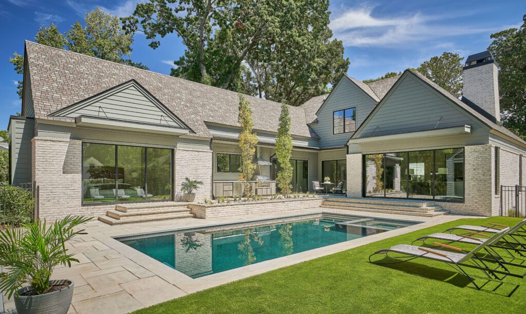 Luxury home backyard with rectangular pool and loungers